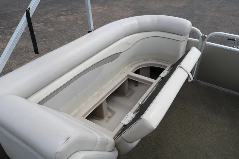 Slide: The Image of 2015 Bennington 24SSRX boat with open storage compartment under cushioned seating. - 13