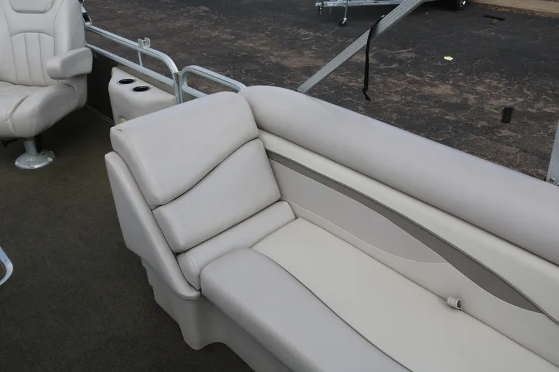 Slide: The Image of 2015 Bennington 24SSRX boat interior with beige seating and armrests. - 14