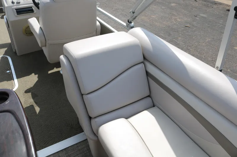 Slide: The Image of 2015 Bennington 24SSRX boat interior with beige seating and carpeted flooring. - 17