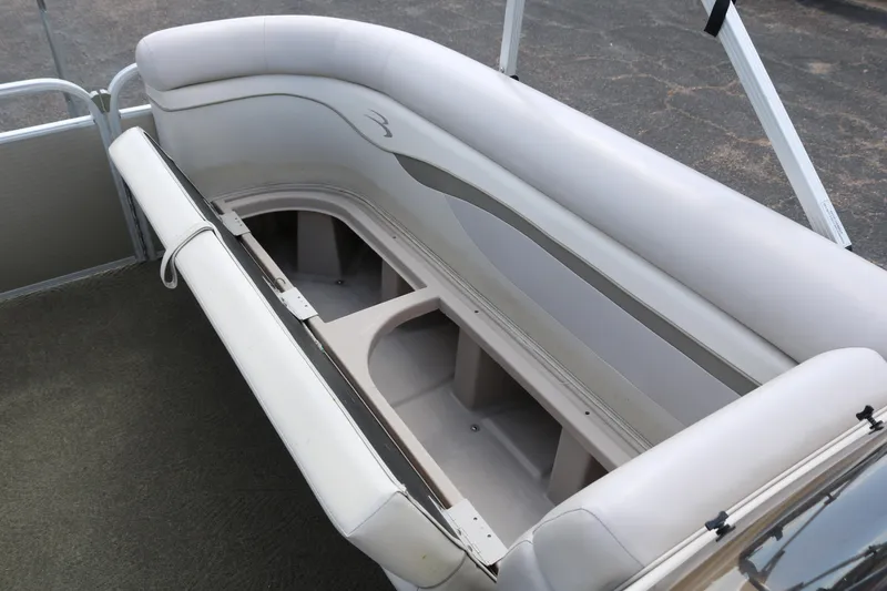 Slide: The Image of 2015 Bennington 24SSRX pontoon boat interior seating with storage compartment open. - 25