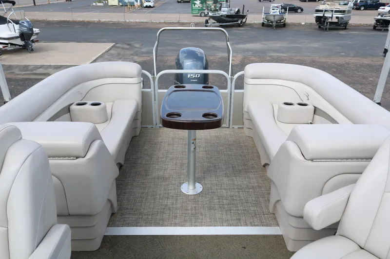 Slide: The Image of 2015 Bennington 24SSRX pontoon boat interior with plush seating and central table. - 26