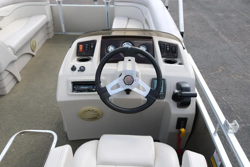 Slide: The Image of 2015 Bennington 24SSRX boat dashboard with steering wheel and controls. - 29