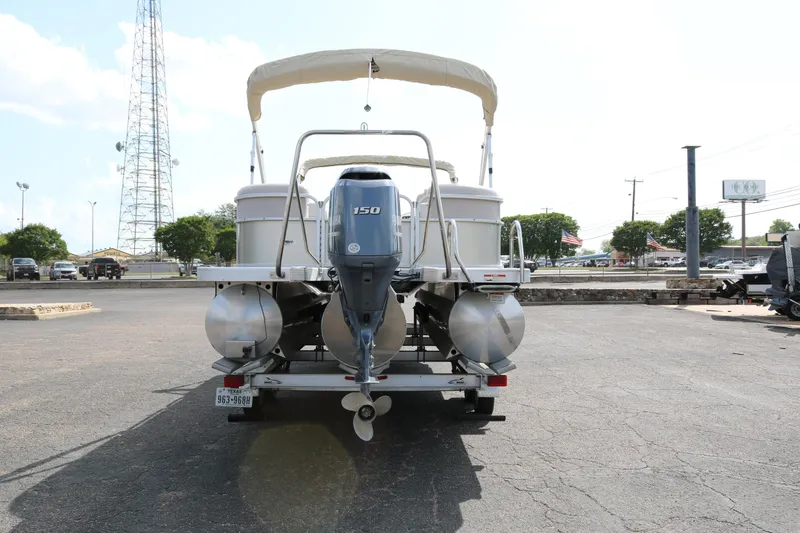 Slide: The Image of 2015 Bennington 24SSRX pontoon boat with Yamaha 150 engine, parked on asphalt. - 6