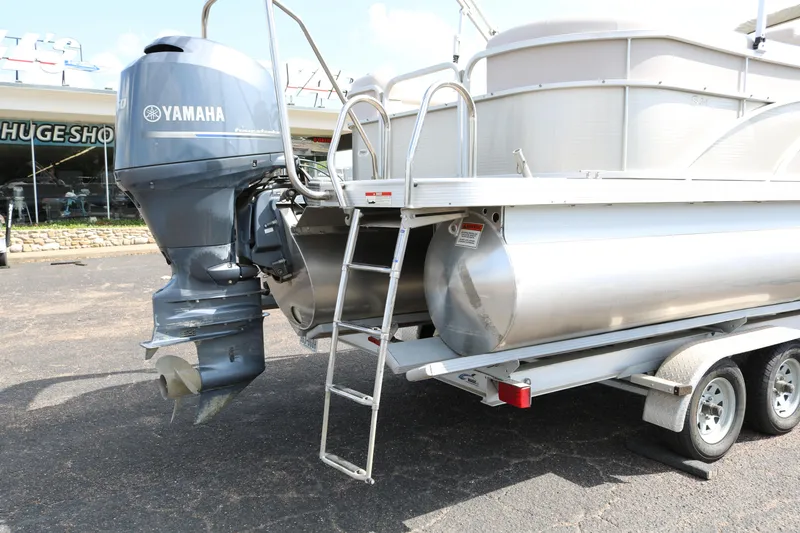 Slide: The Image of 2015 Bennington 24SSRX pontoon boat with Yamaha outboard motor on trailer. - 9