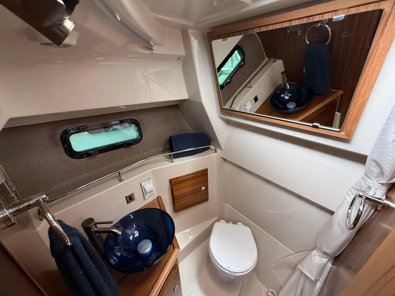 Slide: The Image of Luxurious bathroom in 2025 Ranger Tugs R-27 boat with modern fixtures and elegant design. - 19