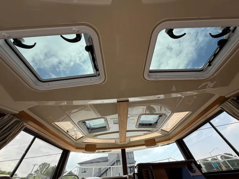 Slide: The Image of Interior view of 2025 Ranger Tugs R-27 with skylights and modern design. - 22