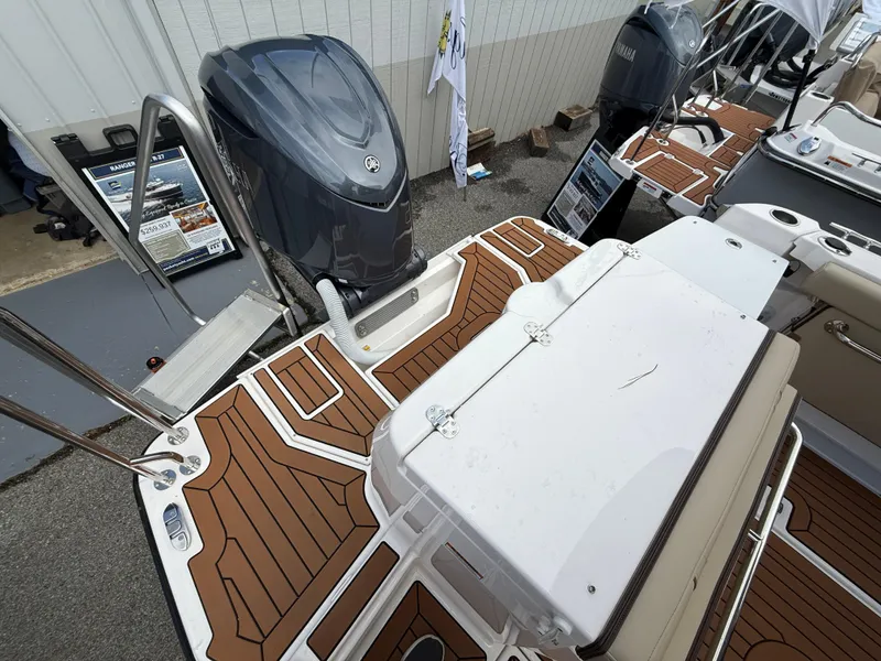 Slide: The Image of 2025 Ranger Tugs R-27 boat deck with outboard motor and seating area. - 5