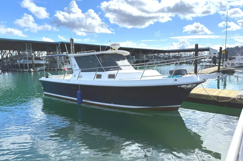 The Image of 2009 Albin 32 TE boat docked in a marina under a partly cloudy sky. - 0