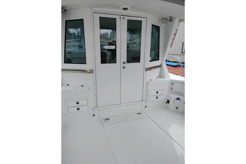 Slide: The Image of 2009 Albin 32 Tournament Express boat interior with white cabinetry and glass doors. - 12