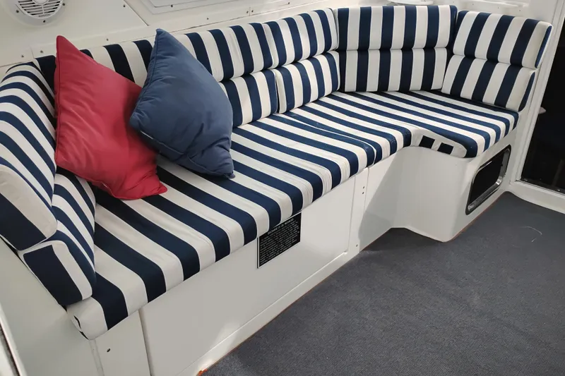 Slide: The Image of Striped seating area with cushions on a 2009 Albin 32 Tournament Express boat. - 13