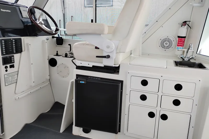 Slide: The Image of Interior of 2009 Albin 32 Tournament Express boat with helm, seating, and kitchenette. - 17
