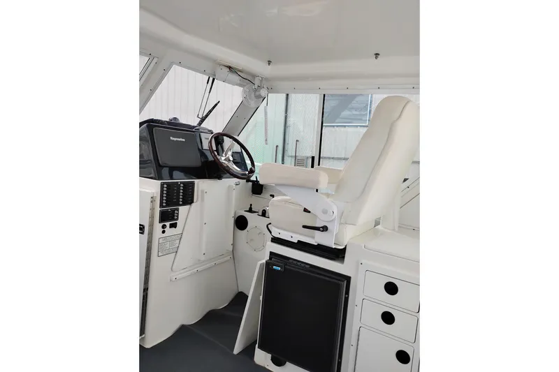 Slide: The Image of Interior helm of 2009 Albin 32 Tournament Express with steering wheel and navigation equipment. - 19