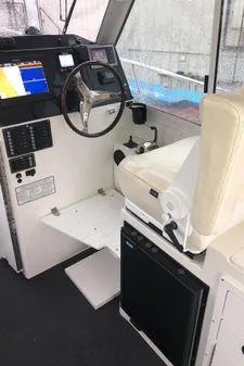 Slide: The Image of 2009 Albin 32 TE boat interior with steering wheel, navigation system, and captain's chair. - 20