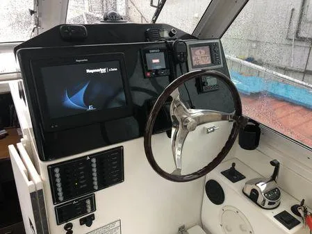 Slide: The Image of 2009 Albin 32 TE boat cockpit with steering wheel and navigation equipment. - 23