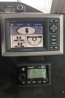 Slide: The Image of Dashboard of a 2009 Albin 32 TE boat with navigation and audio controls. - 25