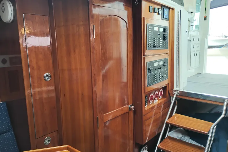 Slide: The Image of Interior of 2009 Albin 32 Tournament Express with wooden cabinetry and control panels. - 29
