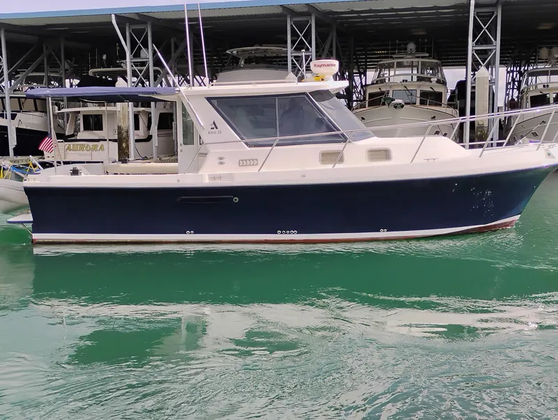 Slide: The Image of 2009 Albin 32 TE boat docked in marina, featuring sleek design and blue hull. - 3