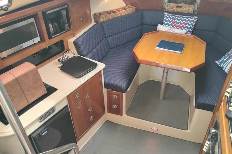 Slide: The Image of Interior of 2009 Albin 32 Tournament Express with kitchenette and cozy seating area. - 30