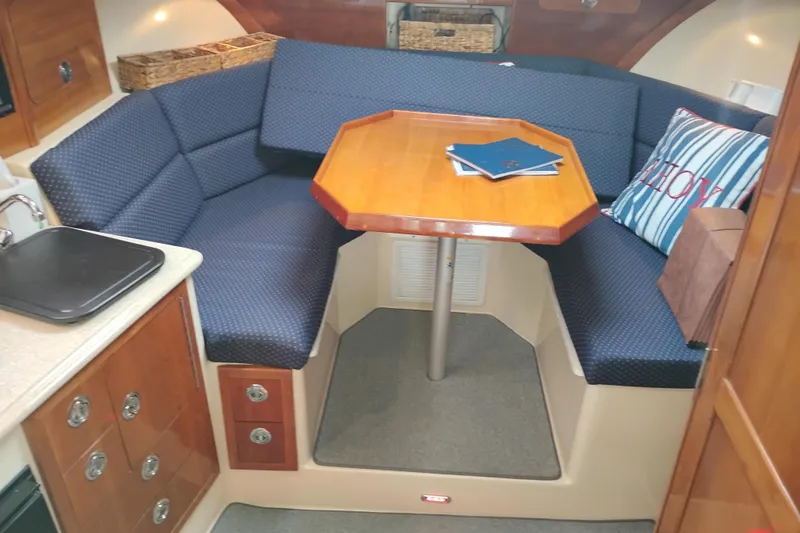 Slide: The Image of Interior of 2009 Albin 32 Tournament Express with cozy seating and wooden table. - 31