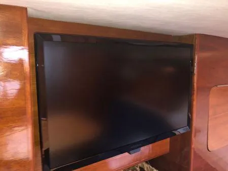 Slide: The Image of Flat-screen TV mounted on wooden interior of 2009 Albin 32 TE boat. - 39