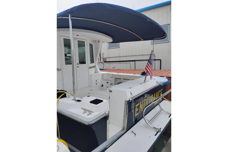 Slide: The Image of 2009 Albin 32 Tournament Express boat with canopy and American flag. - 4