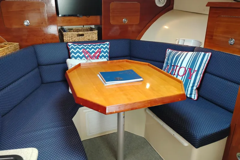 Slide: The Image of Cozy interior of 2009 Albin 32 Tournament Express with blue seating and decorative pillows. - 48