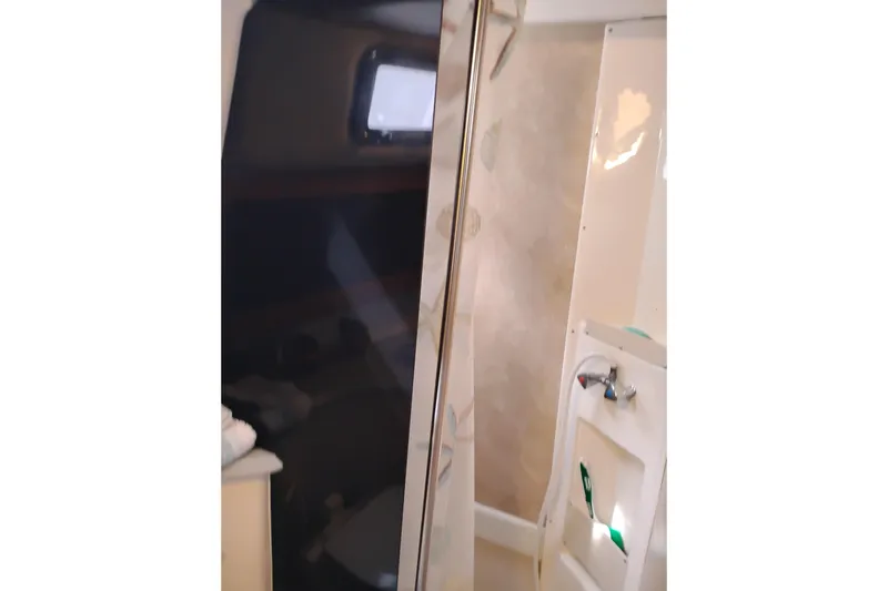 Slide: The Image of Bathroom interior of 2009 Albin 32 Tournament Express boat, featuring shower and sink. - 51