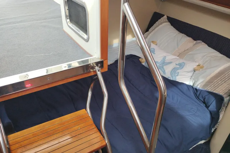 Slide: The Image of Cozy cabin interior of 2009 Albin 32 Tournament Express with bedding and wooden steps. - 53