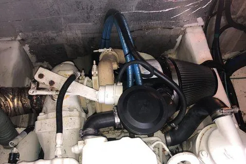 Slide: The Image of Engine compartment of a 2009 Albin 32 TE boat, featuring hoses and mechanical components. - 57