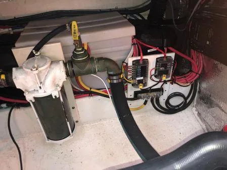 Slide: The Image of Engine compartment of a 2009 Albin 32 TE boat, featuring wiring and plumbing components. - 58