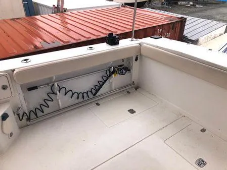 Slide: The Image of 2009 Albin 32 TE boat deck with storage compartments and coiled hose. - 9