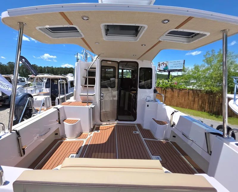 Slide: The Image of 2025 Ranger Tugs R-31 CB boat interior with teak flooring and spacious seating. - 3