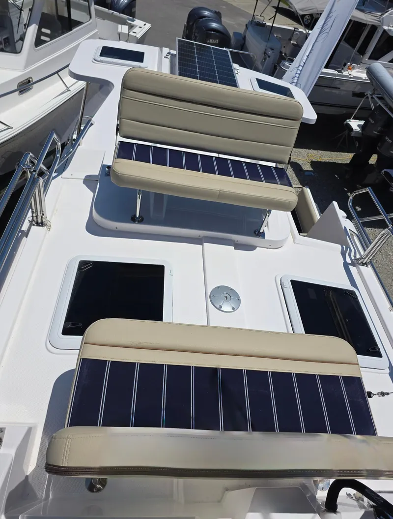 Slide: The Image of 2025 Ranger Tugs R-31 CB boat deck with seating and solar panels. - 5