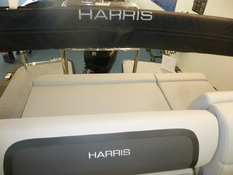 Slide: The Image of 2025 Harris CX 230 boat interior with cushioned seating and branded upholstery. - 3