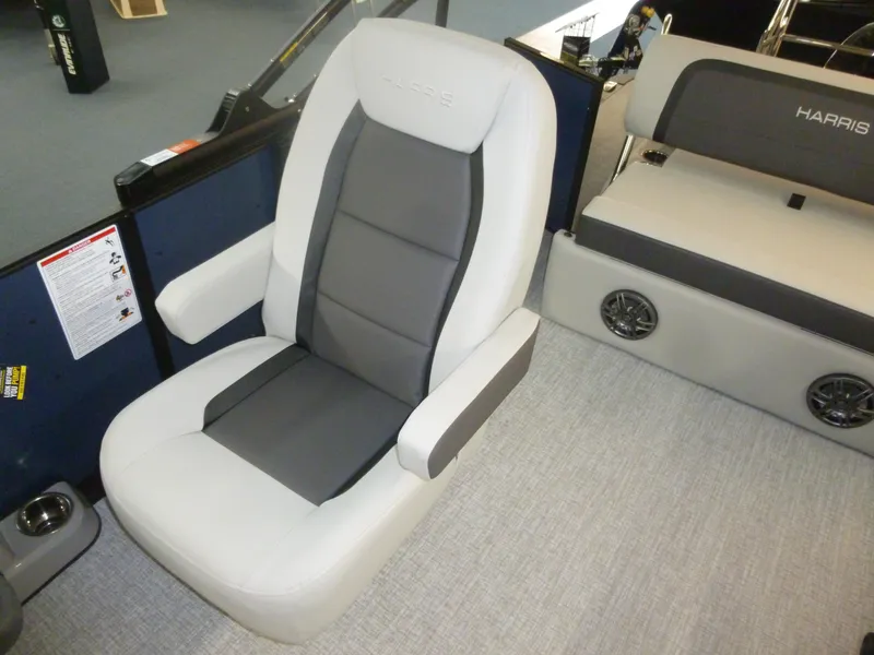 Slide: The Image of Luxurious seating on 2025 Harris CX 230 boat, featuring gray and white upholstery. - 5