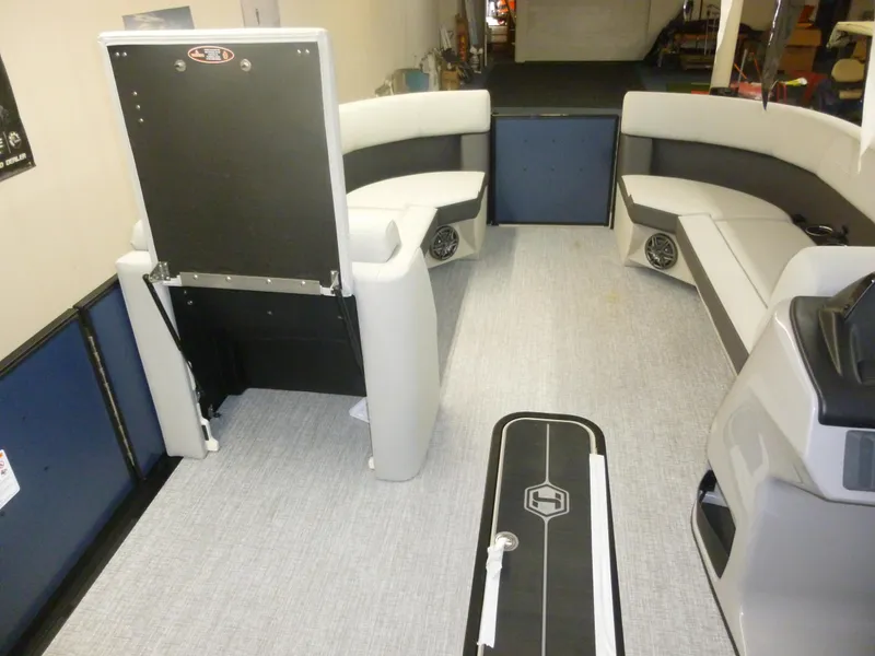 Slide: The Image of Interior of 2025 Harris CX 230 pontoon boat with modern seating and flooring. - 7