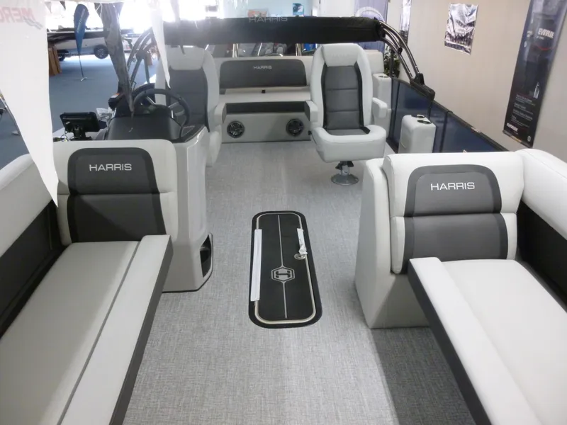 Slide: The Image of 2025 Harris CX 230 pontoon boat interior with gray seating and modern design. - 8