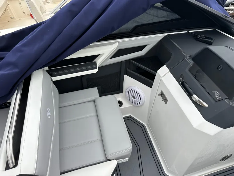 Slide: The Image of 2022 Cobalt R8 Surf boat interior with gray seating and modern design elements. - 11