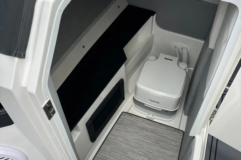Slide: The Image of 2022 Cobalt R8 Surf boat interior with compact marine toilet. - 22