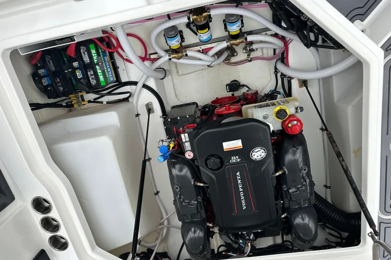 Slide: The Image of Engine compartment of a 2022 Cobalt R8 Surf boat, featuring Volvo Penta engine components. - 25