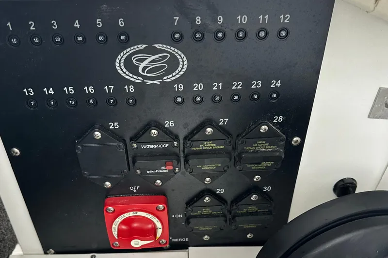 Slide: The Image of Control panel of a 2022 Cobalt R8 Surf boat with switches and red power knob. - 26