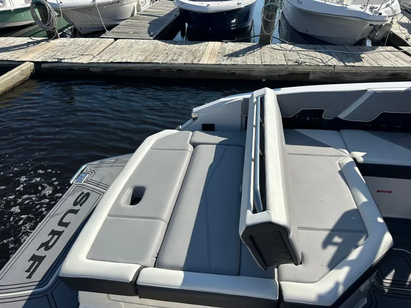Slide: The Image of 2022 Cobalt R8 Surf boat with gray seating at a marina dock. - 38