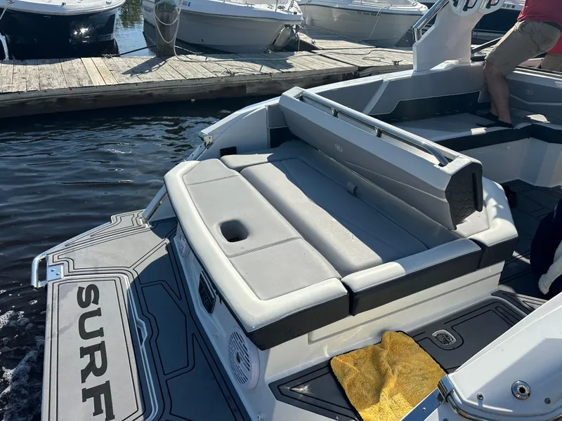 Slide: The Image of 2022 Cobalt R8 Surf boat with gray seating, docked at marina. - 39