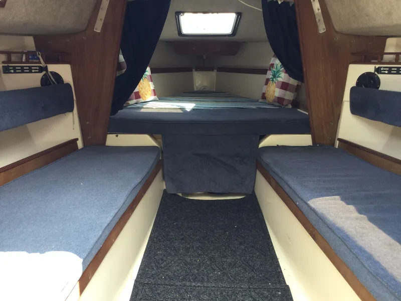 Slide: The Image of Interior of a 1987 Precision P23 sailboat with blue cushions and wood accents. - 10