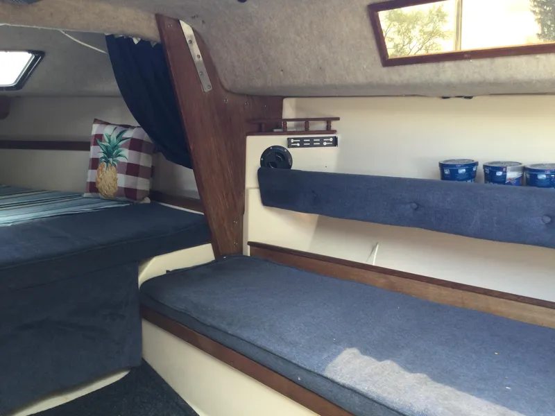 Slide: The Image of Interior of a 1987 Precision P23 sailboat with cozy seating and nautical decor. - 13