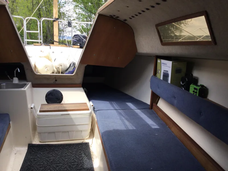 Slide: The Image of Interior of a 1987 Precision P23 sailboat with seating, sink, and storage. - 16