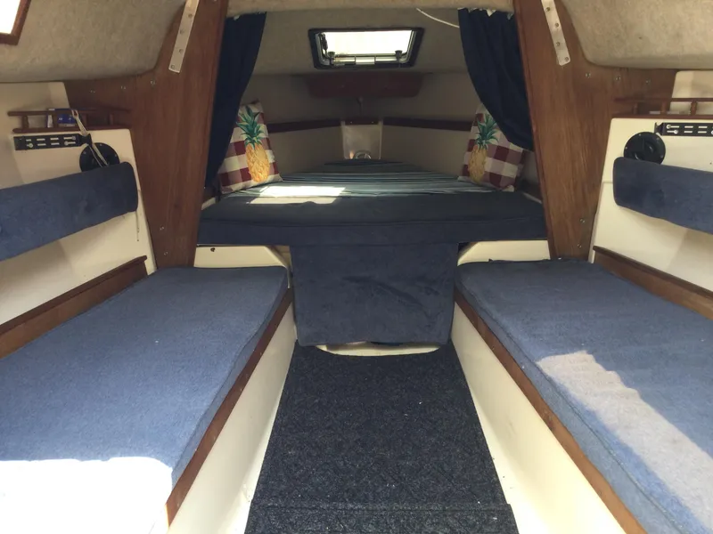 Slide: The Image of Interior of a 1987 Precision P23 sailboat with blue cushions and wooden accents. - 19