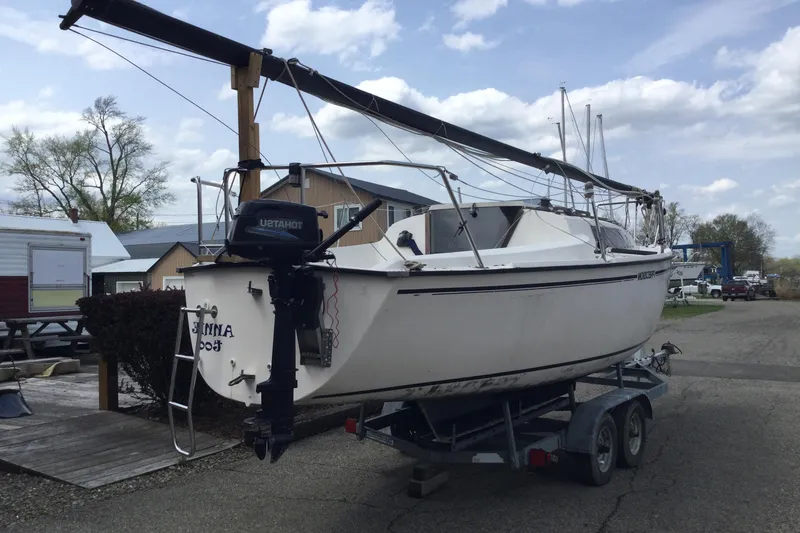 Slide: The Image of 1987 Precision P23 sailboat on trailer, parked outdoors under cloudy sky. - 6