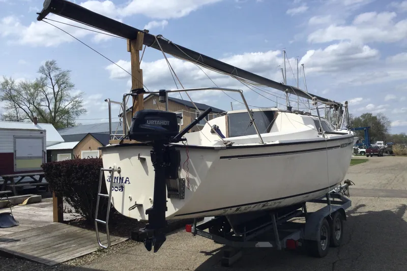 Slide: The Image of 1987 Precision P23 sailboat on trailer, parked outdoors under a cloudy sky. - 7