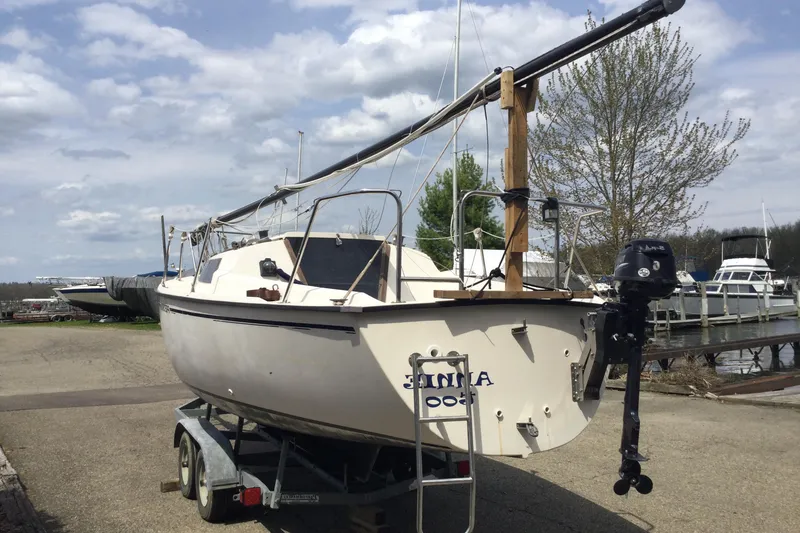Slide: The Image of 1987 Precision P23 sailboat on trailer, dockside, under cloudy sky. - 8